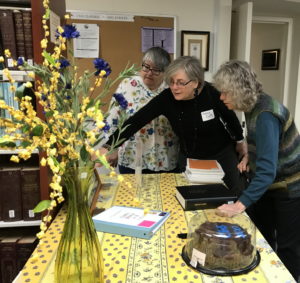 Three women standing by table