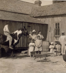 family group with horse and barn