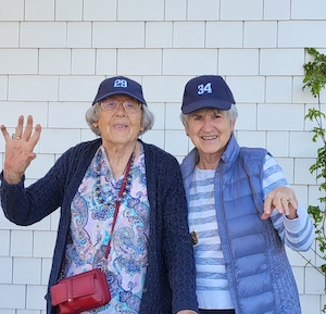 two women in ball caps