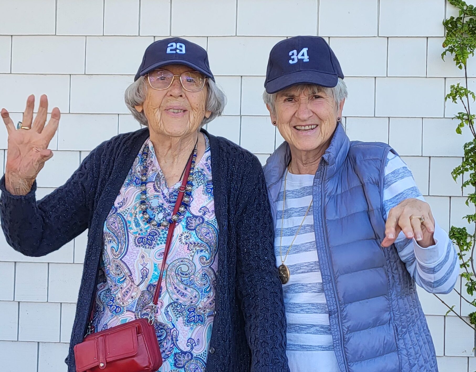 Two women in baseball caps