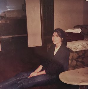 Debbie sitting on Grampa's floor watching MTV